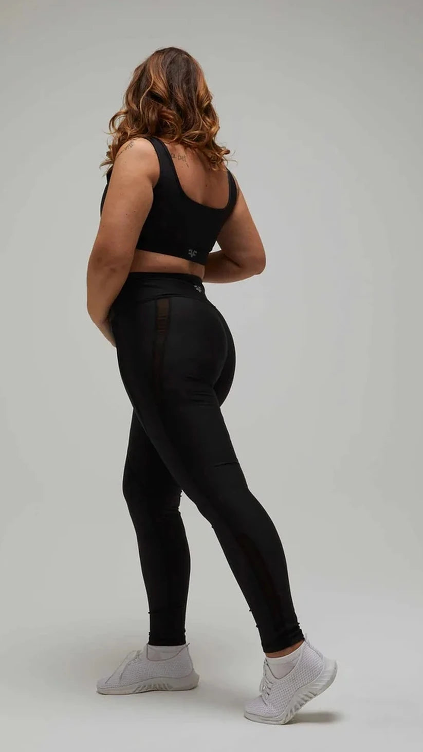 Leggings neri Flexivel con inserti in rete e top sportivo nero, vista laterale di spalle
